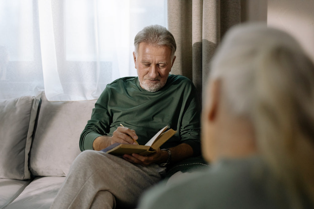A grandpa looking at his gift - a memory book of his memoirs