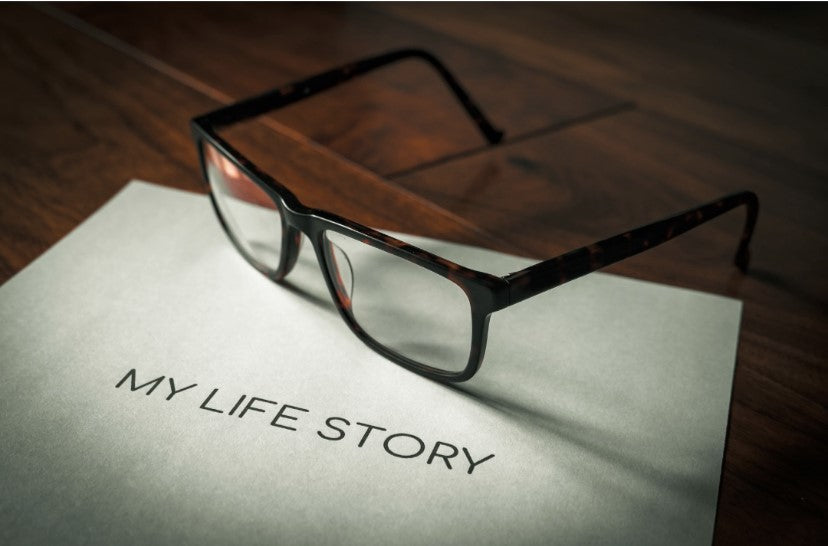Glasses resting on a My Life Story manuscript